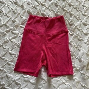 Daily Drills ribbed shortie shorts in cheek. A hot pink color.